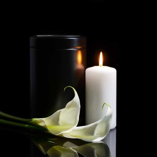mortuary-urn-burning-candle-flowers-dark-background